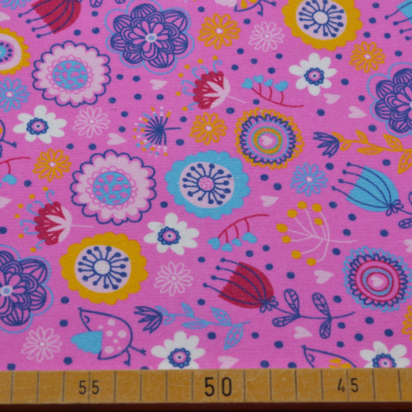 Baumwoll-Jersey in Pink mit bunten Blumenmuster – elastischer Stoff für Modeprojekte.
